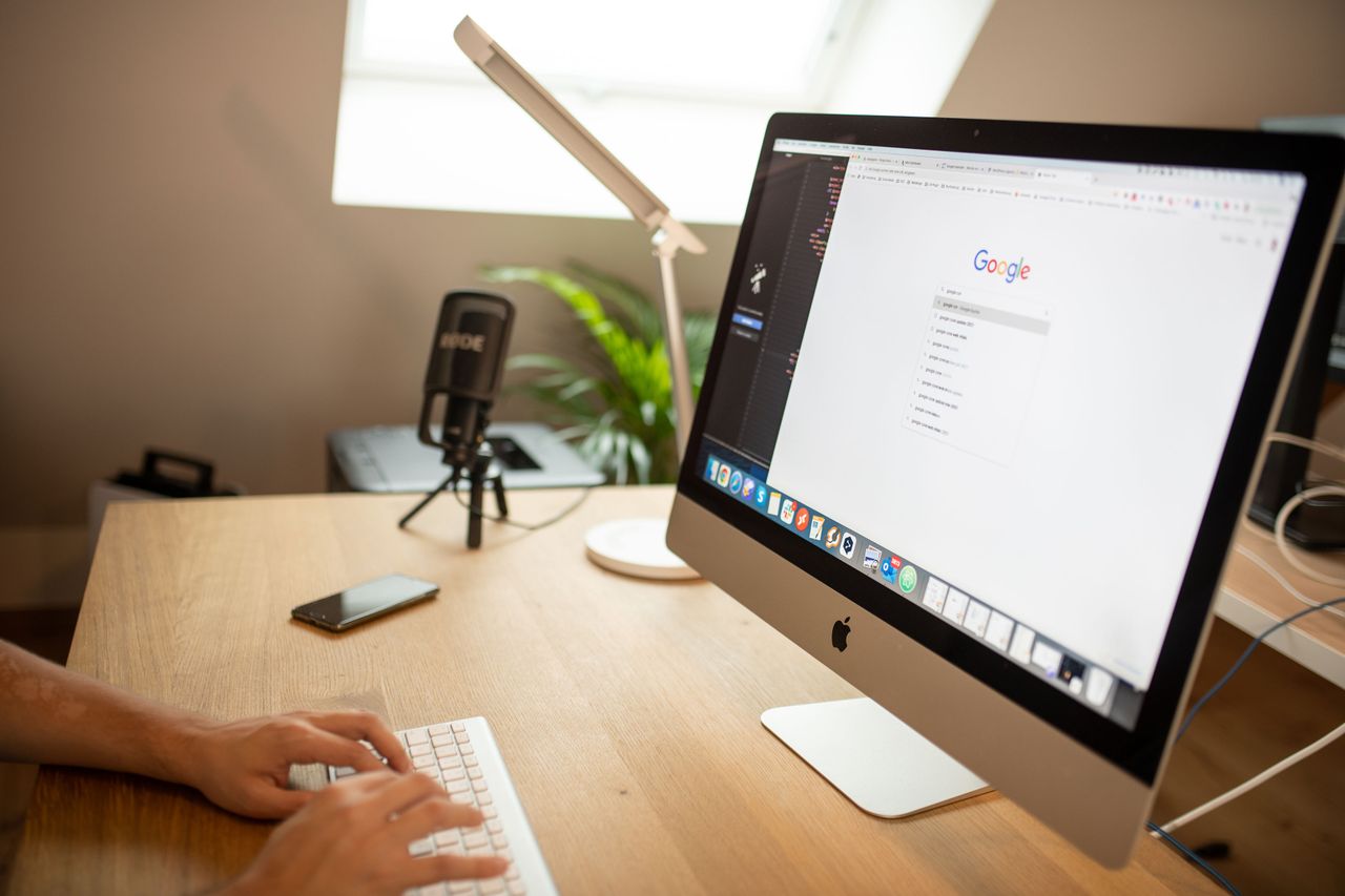 The Art of Drawing Readers In: Your attractive post title goes here A modern workspace with an iMac displaying Google search, perfect for remote work setups.